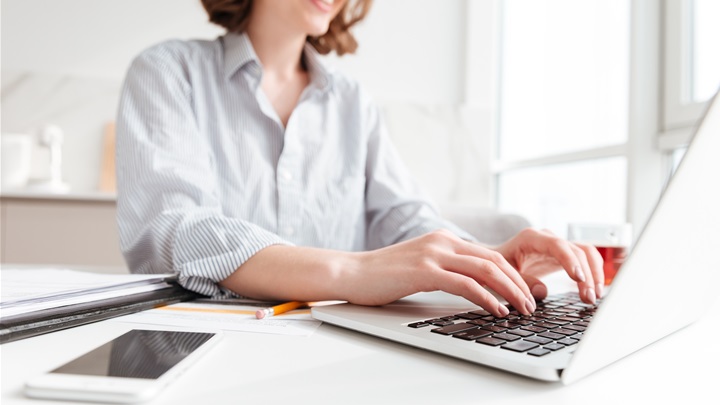 brunette-woman-typing-email-laptop-computer-while-sitting-home-selective-focus-hand (1).jpg