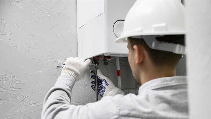 worker-repairing-water-heater.jpg