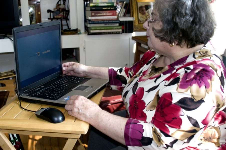 granny-seated-at-a-small-folding-table-atop-which-was-a-laptop-computer-850x565.jpg