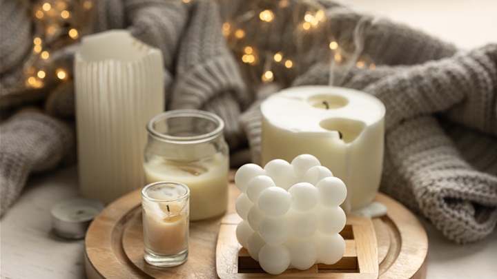cozy-composition-with-candles-knitted-element-garland.jpg